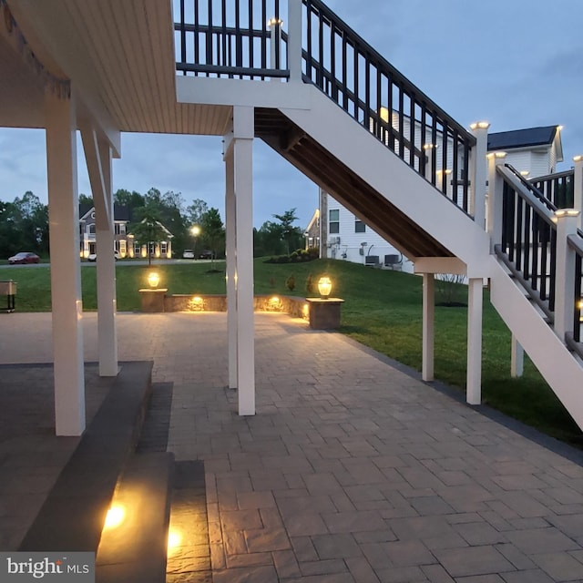 view of patio with stairway and a fire pit