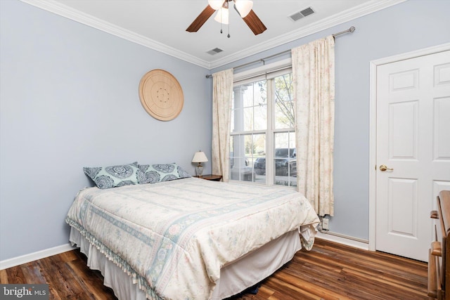 bedroom featuring wood finished floors, visible vents, ornamental molding, and baseboards