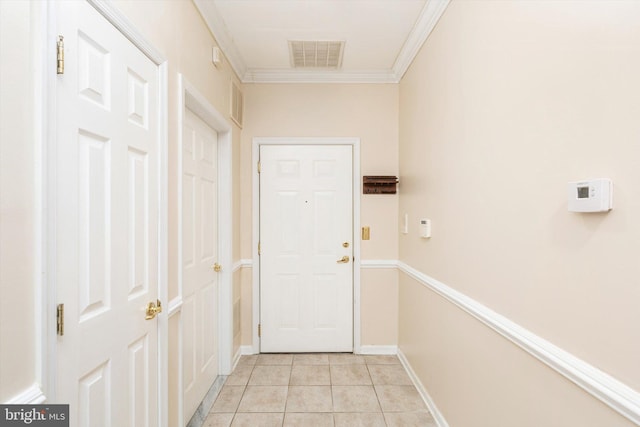 doorway to outside with light tile patterned floors, visible vents, ornamental molding, and baseboards