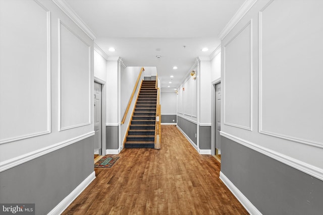 hallway featuring recessed lighting, ornamental molding, and baseboards