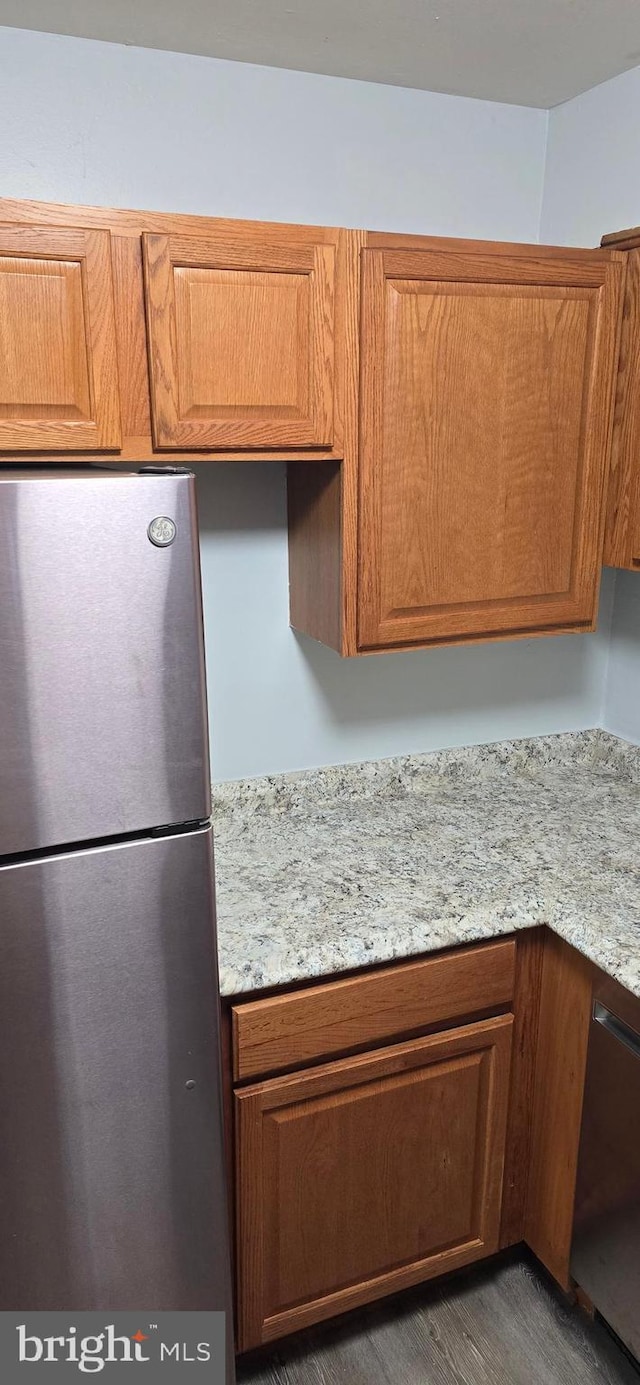 3811 Swann Rd Unit T-1, Suitland, MD 20746 - kitchen with brown cabinets, light stone countertops, and appliances with stainless steel finishes