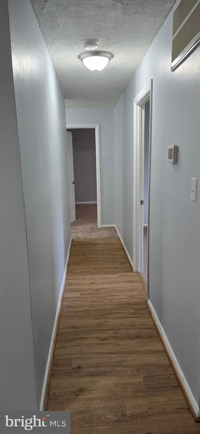 3811 Swann Rd Unit T-1, Suitland, MD 20746 - corridor featuring a textured ceiling, baseboards, and wood finished floors