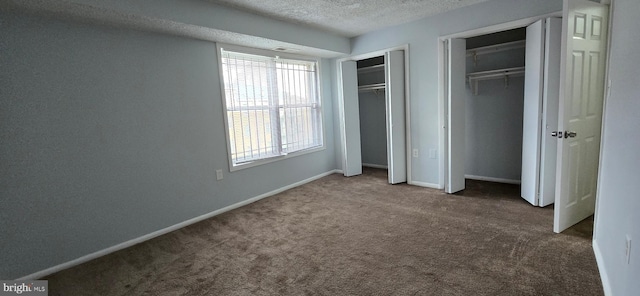 3811 Swann Rd Unit T-1, Suitland, MD 20746 - unfurnished bedroom with baseboards, carpet flooring, a textured ceiling, and two closets