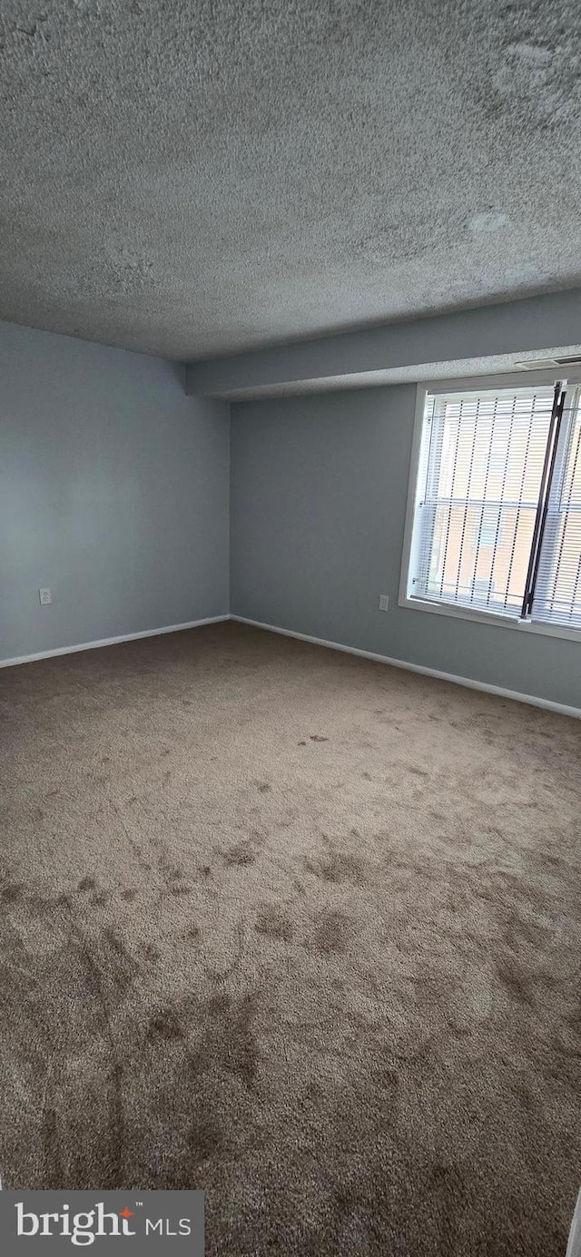 3811 Swann Rd Unit T-1, Suitland, MD 20746 - carpeted empty room with baseboards and a textured ceiling