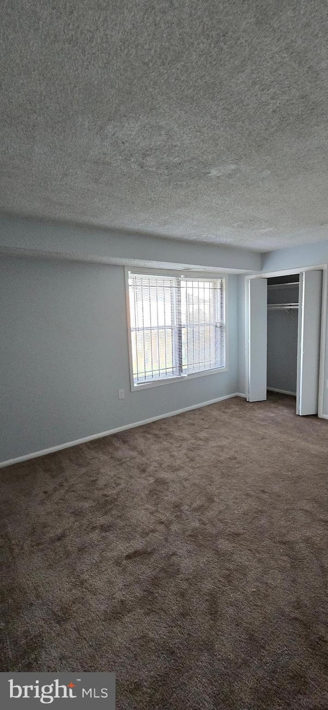 3811 Swann Rd Unit T-1, Suitland, MD 20746 - unfurnished bedroom featuring carpet floors, a textured ceiling, and baseboards