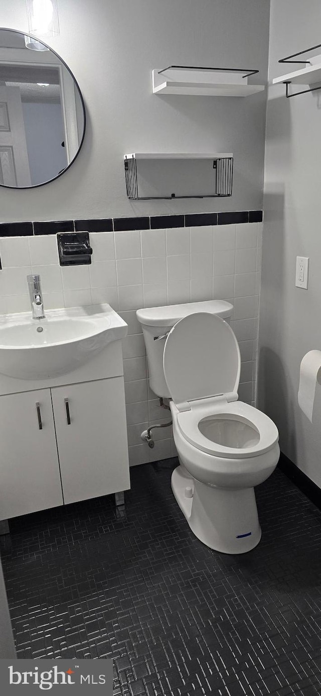 3811 Swann Rd Unit T-1, Suitland, MD 20746 - bathroom featuring vanity, a wainscoted wall, toilet, and tile walls