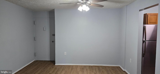 3811 Swann Rd Unit T-1, Suitland, MD 20746 - spare room featuring a textured ceiling, ceiling fan, baseboards, and wood finished floors
