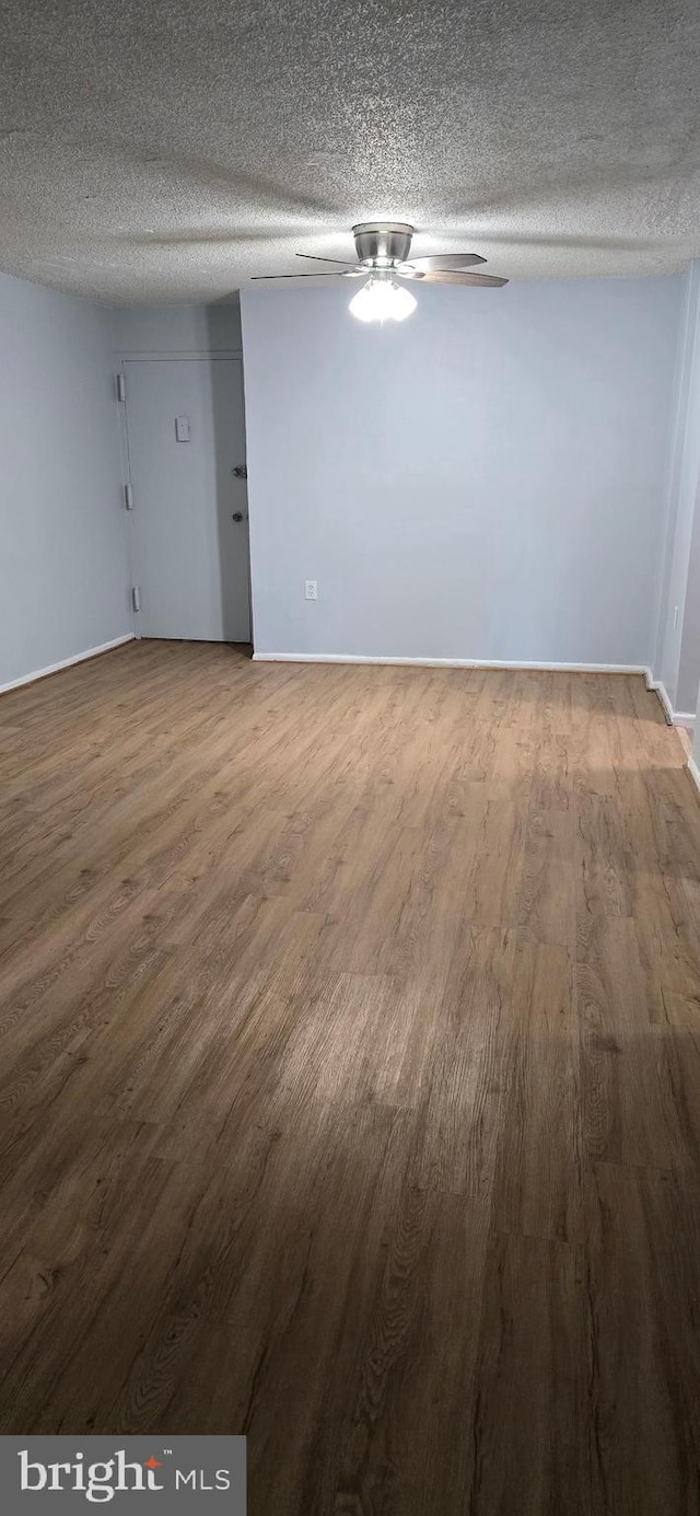 3811 Swann Rd Unit T-1, Suitland, MD 20746 - unfurnished room featuring baseboards, a textured ceiling, ceiling fan, and wood finished floors
