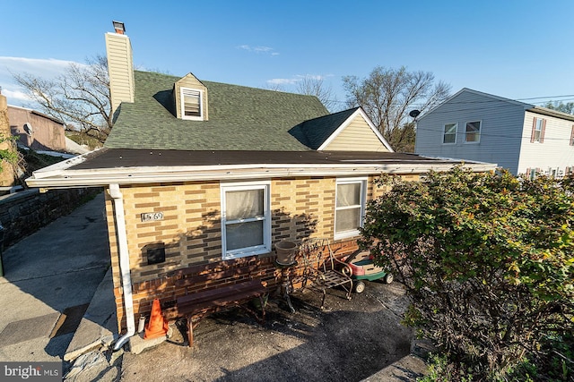 1569 Prospect Ave, Willow Grove, PA 19090 - rear view of property featuring a chimney, brick siding, and a shingled roof