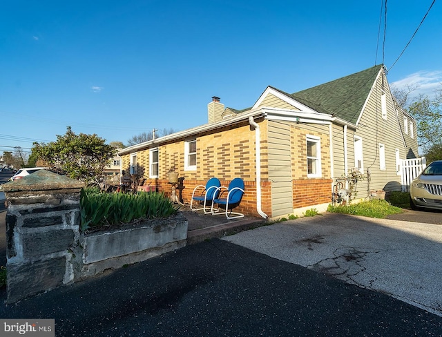 1569 Prospect Ave, Willow Grove, PA 19090 - view of side of home featuring a chimney and brick siding