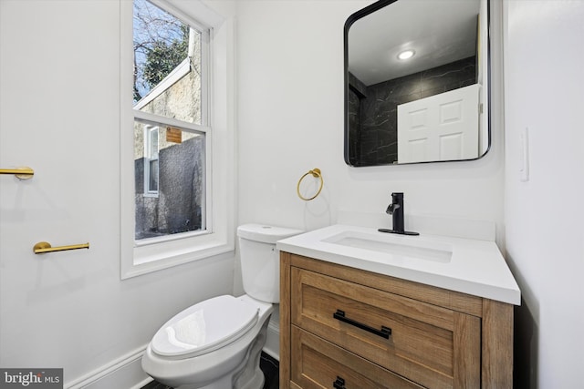 bathroom featuring toilet and vanity