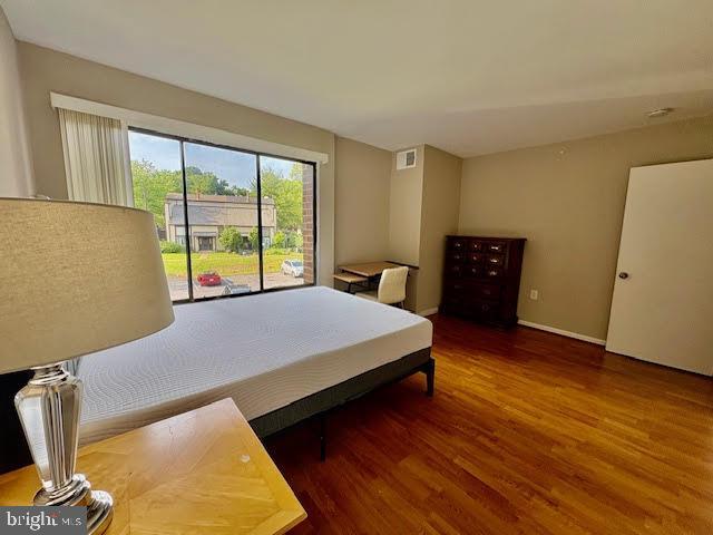 15702 Dorset Rd Unit 204, Laurel, MD 20707 - bedroom with wood finished floors, access to exterior, and baseboards