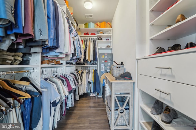 walk in closet with visible vents and wood finished floors