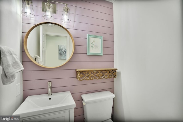 half bath featuring toilet and a sink