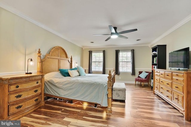bedroom featuring baseboards, a ceiling fan, wood finished floors, and ornamental molding