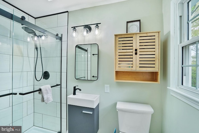 full bathroom with vanity, a shower stall, and toilet