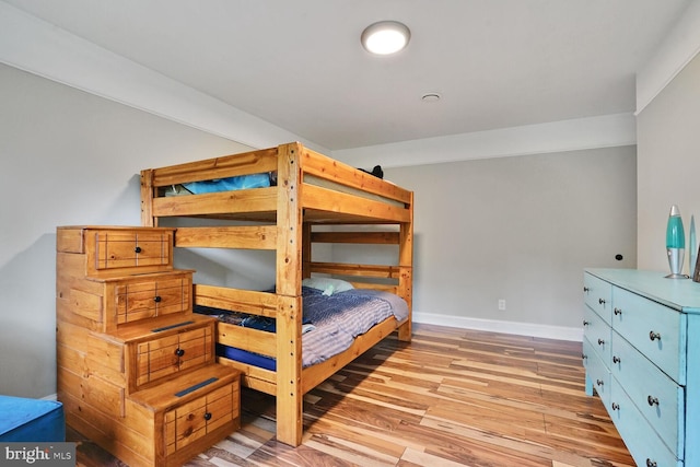 bedroom featuring baseboards and light wood-style floors