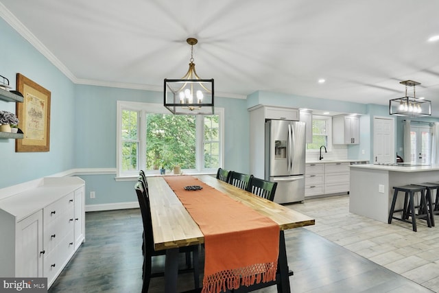 dining area with a chandelier, a healthy amount of sunlight, and light wood finished floors