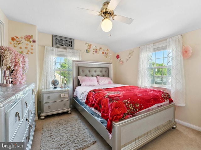 bedroom with baseboards, ceiling fan, and light carpet
