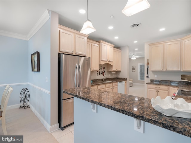 kitchen featuring dark stone counters, freestanding refrigerator, recessed lighting, ceiling fan, and dishwasher