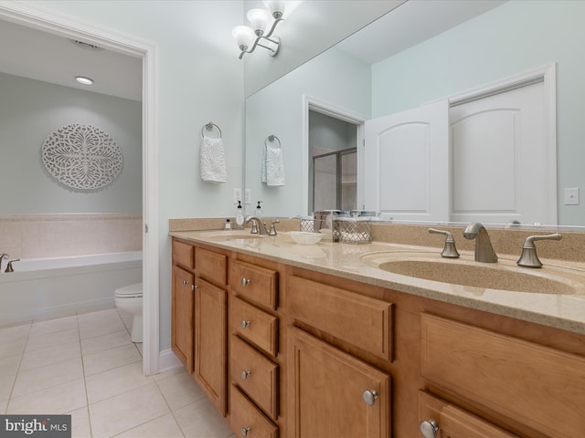 bathroom featuring tile patterned floors, a sink, a shower stall, and double vanity