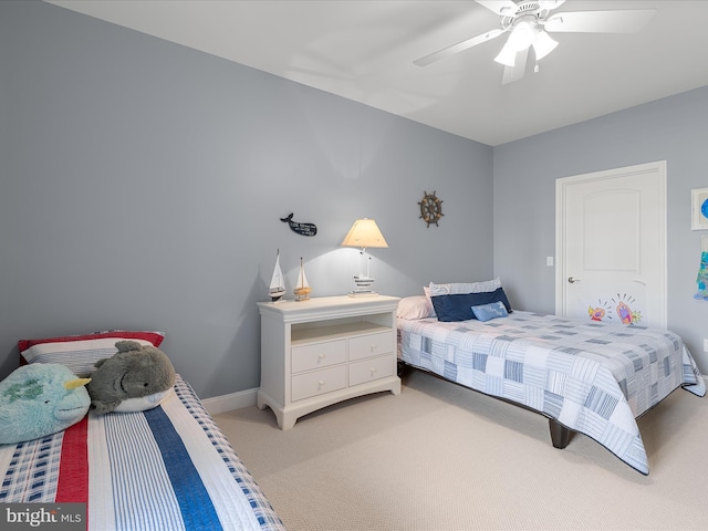 bedroom with ceiling fan, light carpet, and baseboards