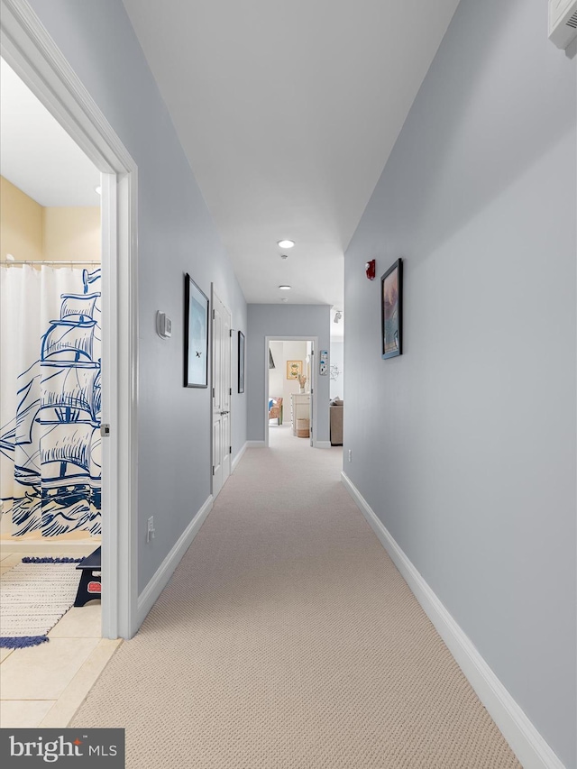 hallway with baseboards, recessed lighting, and carpet flooring