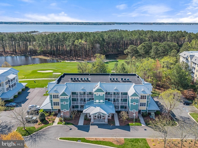 birds eye view of property with golf course view and a water view