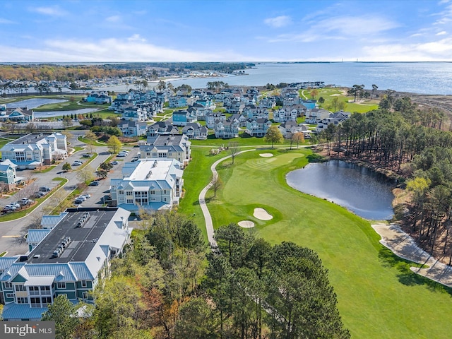 birds eye view of property with view of golf course, a water view, and a residential view