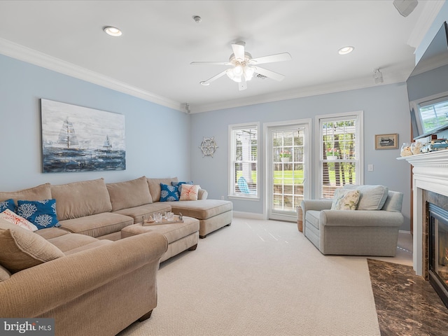 living area with a fireplace with flush hearth, carpet flooring, recessed lighting, ceiling fan, and ornamental molding