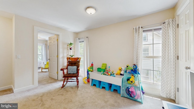 rec room featuring carpet flooring and baseboards