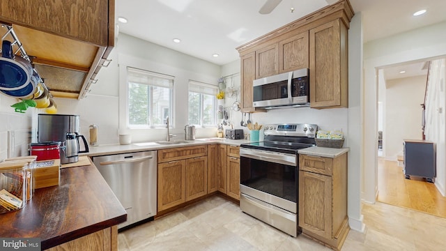 kitchen featuring stainless steel appliances, recessed lighting, a sink, ceiling fan, and light tile patterned flooring