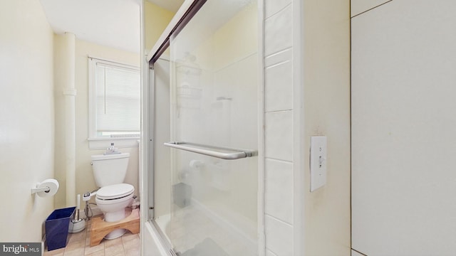 bathroom with an enclosed shower and toilet