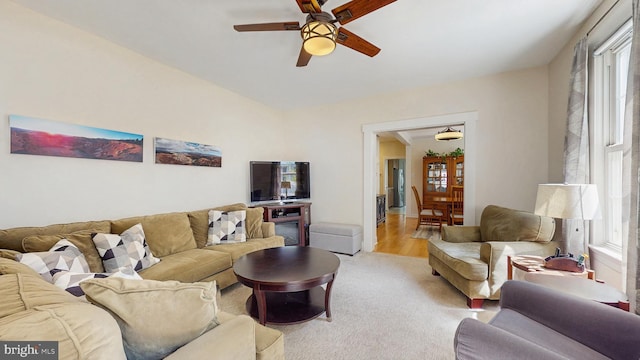 living area featuring ceiling fan and light carpet
