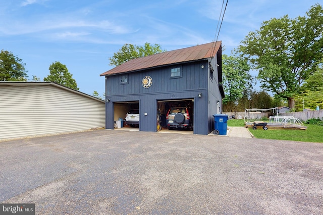 garage featuring a garage and fence