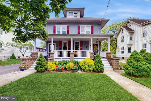traditional style home featuring covered porch, a front yard, and stairway