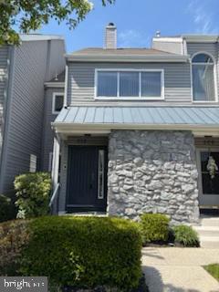 exterior space with a standing seam roof, metal roof, and a chimney