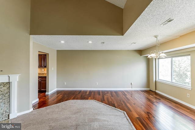 510 Chanticleer, Cherry Hill, NJ 08003 - unfurnished living room featuring dark wood-style floors, a textured ceiling, a chandelier, and baseboards