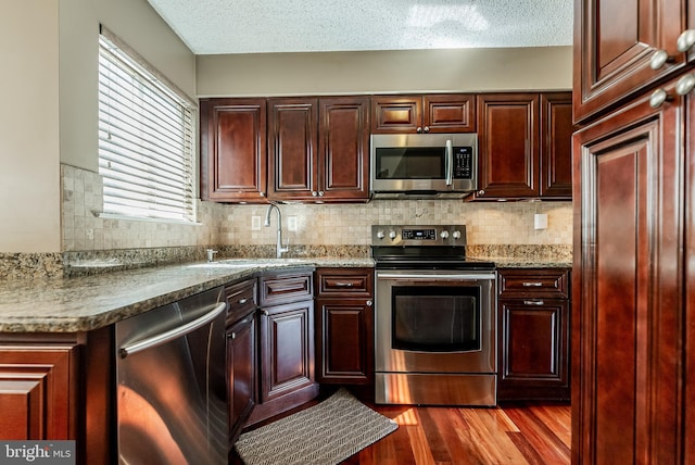 510 Chanticleer, Cherry Hill, NJ 08003 - kitchen with appliances with stainless steel finishes, a sink, dark wood-style flooring, backsplash, and a textured ceiling