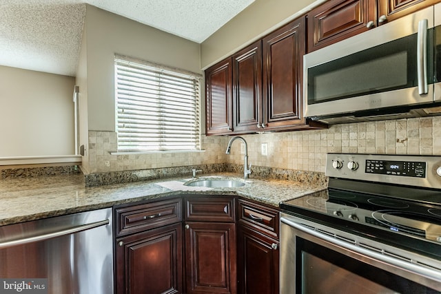 510 Chanticleer, Cherry Hill, NJ 08003 - kitchen with stainless steel appliances, a sink, a textured ceiling, backsplash, and stone countertops