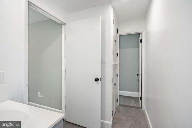 bathroom featuring baseboards and vanity