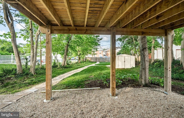 view of yard featuring a storage shed and an outdoor structure