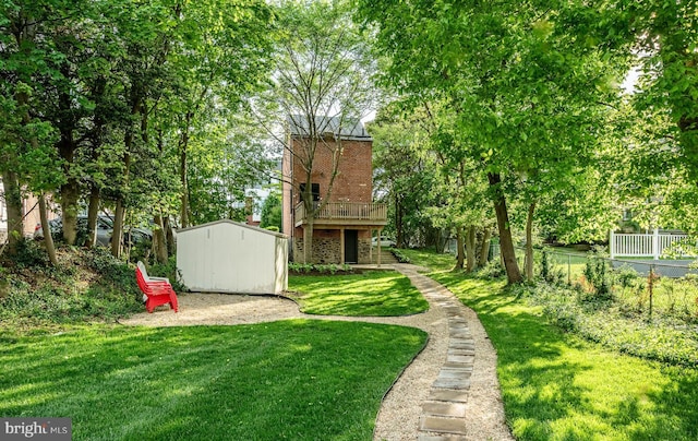 view of yard with a storage unit, an outbuilding, and a wooden deck