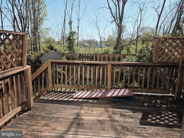 wooden terrace featuring fence