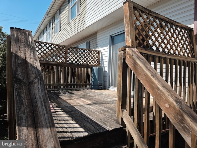 wooden terrace featuring cooling unit