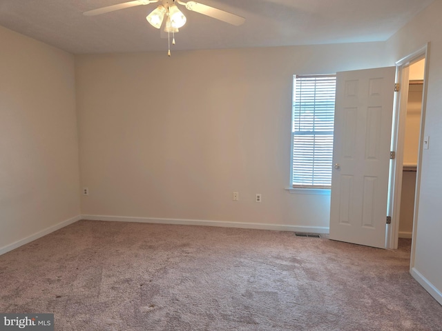 unfurnished bedroom featuring visible vents, carpet flooring, baseboards, and a ceiling fan