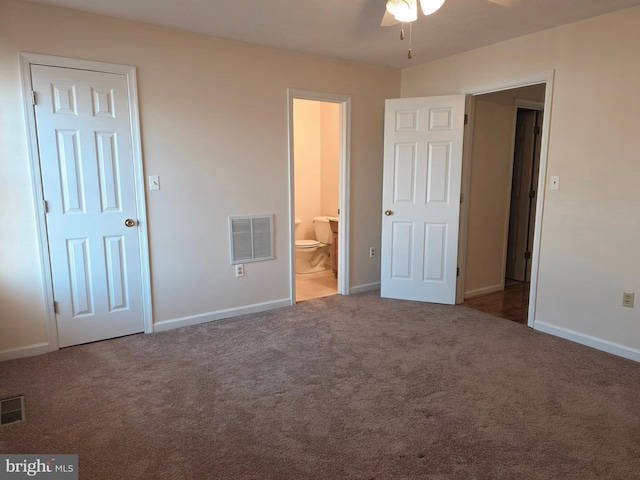 unfurnished bedroom featuring ensuite bath, visible vents, carpet flooring, and baseboards