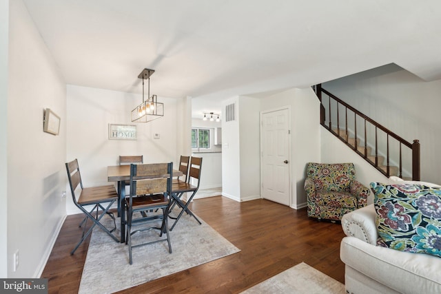 14724 Flower Hill Dr, Centreville, VA 20120 - dining area with baseboards, stairs, visible vents, and wood finished floors