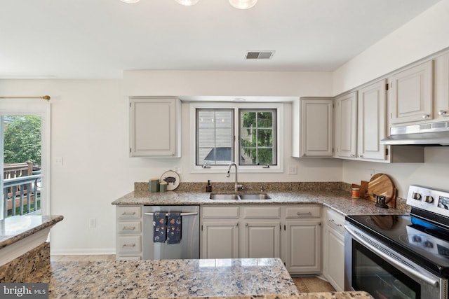 14724 Flower Hill Dr, Centreville, VA 20120 - kitchen with a sink, stainless steel appliances, visible vents, under cabinet range hood, and light stone countertops
