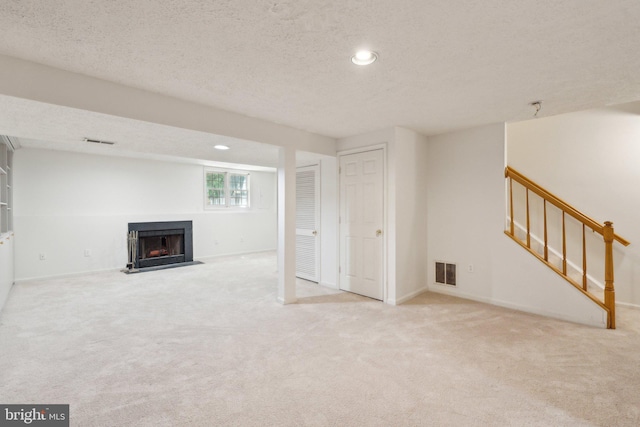 14724 Flower Hill Dr, Centreville, VA 20120 - basement with recessed lighting, carpet flooring, visible vents, a fireplace with flush hearth, and stairway